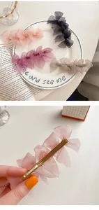 Detailed close-up of multi-layered lace bow hair clips with durable gold alloy spring grips