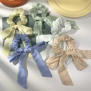 Haarelastiekjes met polkadots en striklinten in diverse pastelkleuren voor dames