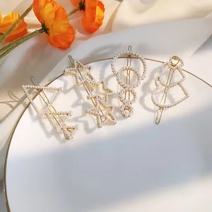 Elegant 4-piece pearl hair clip set with star, tree, and snowman shapes on gold alloy base