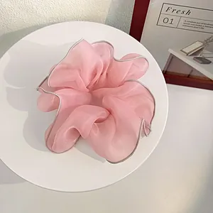 Detail shot of a large pink organza scrunchie with elegant silver stitched edges