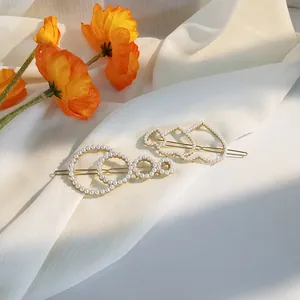 Elegant Korean style gold hair clips set with white pearls in heart and circle designs