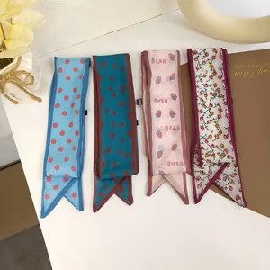 Detail view of four elegant patterned skinny silk scarves for women with pointed ends