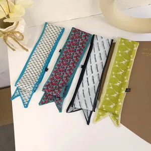 Detail of four floral mesh hair scarves with diverse patterns on a white table decoration