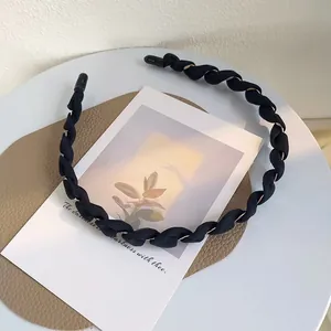 Elegante cerchietto in tessuto intrecciato nero con fili dorati e punte protettive nere