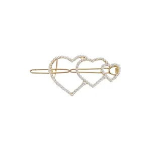 Elegant gold hair clip featuring triple pearl heart design in Korean style