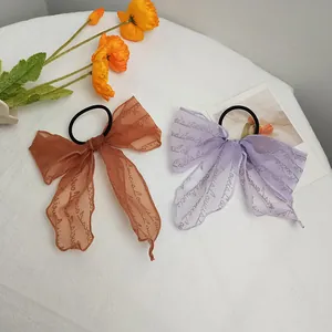 Lace-textured long ribbon bow hair scrunchie with LoveisLoveis cursive print