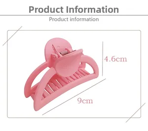 Macro detail of a 9cm pink matte hair claw clip showing size and metal spring structure