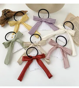 Flat lay of colorful satin bow hair ties set with elegant vintage decorative elements