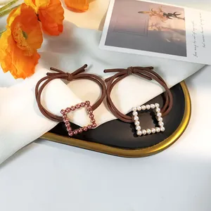 Set of two vintage pearl hair ties with brown elastic bands and square alloy beads