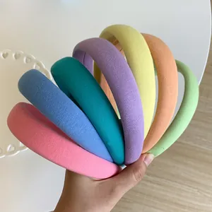 Close-up of assorted candy-colored padded sponge headbands with soft knitted texture