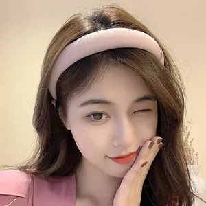 Detailed close-up of a padded pink sponge headband worn by a model in a lifestyle setting