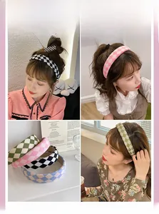 Detail of checkerboard padded headbands in black, pink, green, and blue fabric