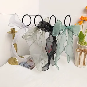 Detail view of colorful bow hair ties with translucent mesh ribbons and ruffled edges