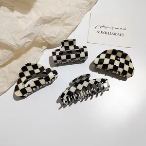 Detailed set of black and white checkered acetate hair claws in various geometric shapes