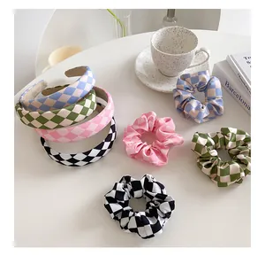 Flat lay of checkered fabric headbands and scrunchies in blue, green, pink and black