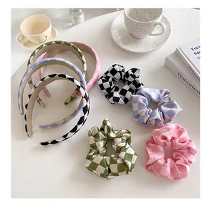 Flat lay of checkerboard headband and scrunchie sets in pastel pink, green, and blue