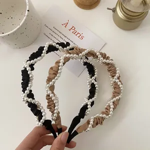 Detail of French vintage headbands featuring elegant pleated fabric and faux pearl wraps