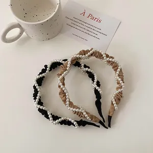 Detail of elegant French retro pleated headband with pearls in black and khaki colors