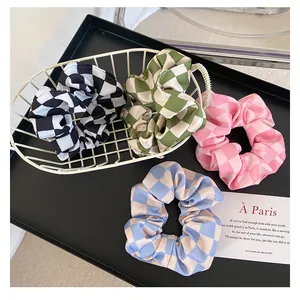 Retro checkered scrunchies set in four colors with satin finish in a stylish metal basket