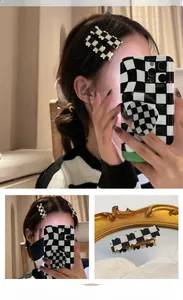 Detail of black and white checkerboard wave hair clip with gold metal alligator grip