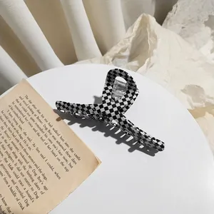 Large checkerboard acetate hair claw clip with black and white pattern for women