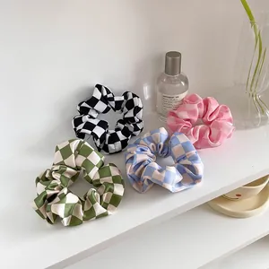 Set of four satin checkered hair scrunchies in black, pink, blue, and green colors