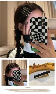Wavy edge hair clip in black and white checkers shown on model's hair with detail