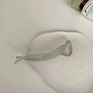 Detailed close-up of matte resin banana hair clip with secure internal teeth structure