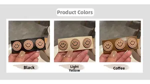 Three leather hair clips with smiley face patches in black, yellow, and coffee brown