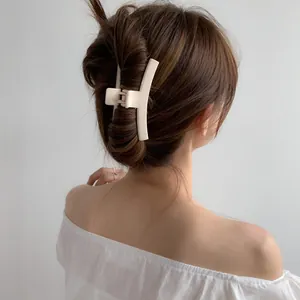 Elegant cream matte acrylic hair claw clip for women in a minimalist geometric design