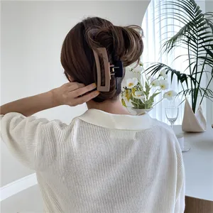 Brown and black matte hair claw clips for thick hair styling in elegant bun updo