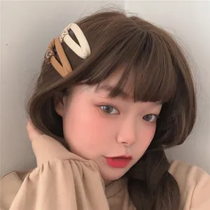 Detail of model wearing pleated PU leather drop hair clips with minimalist smiley face icons