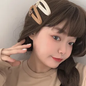 Minimalist PU leather teardrop hair clips in earth tones featuring cute smiley face patterns