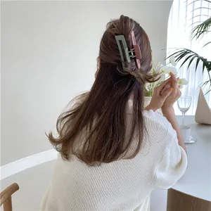 Matte square hair claw clip in bicolor pink and green on long brown hair back view