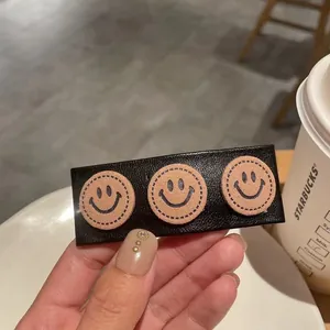 French vintage black PU leather hair clip with cute stitched smiley face patches