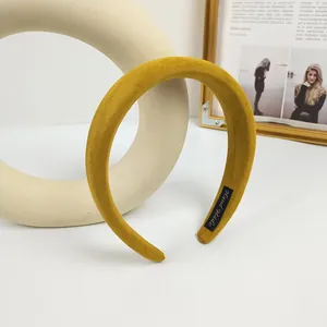 Detalle de diadema de terciopelo amarillo jengibre hecha a mano con textura acolchada