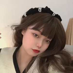 French vintage black velvet headband with white pearl accents on elegant female model