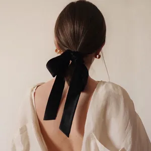 French retro black velvet bow hair tie with long ribbons on model low ponytail