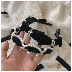 Detail of velvet headbands with pearls and bow in elegant French vintage style