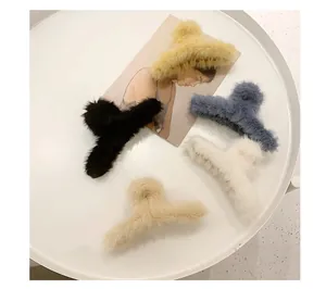 Set of four plush faux fur hair claw clips in black, beige, white and blue colors