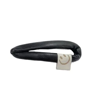 Minimalist black PU leather hair clip with smiley face tag and lychee texture