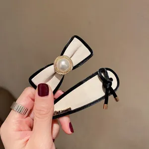 French vintage hair clip set with cream leather bow and pearl accents for women