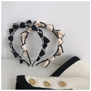 Detail of French vintage bow headbands with contrast stitching and satin pleated texture