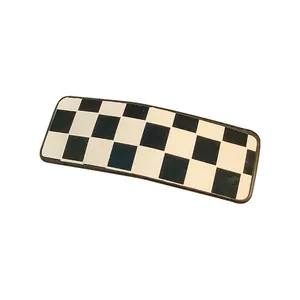 Classic black and white checkerboard pattern rectangular hair clip with a vintage aesthetic