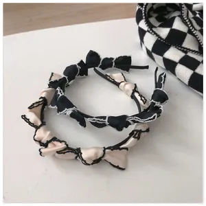 Detail of French vintage bow headbands with contrast stitching and elegant wavy edges