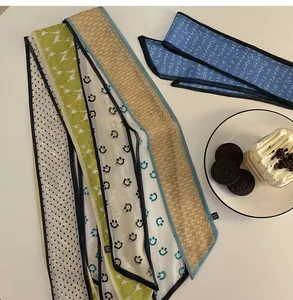 Detail of elegant chiffon twilly hair ribbons with diverse floral and polka dot patterns