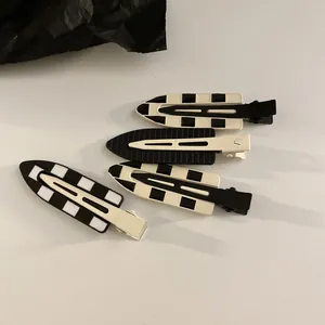 Set of four black and white checkered and solid color seamless hair clips for women