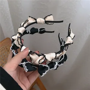 French vintage satin headband set with lace edges and small bows in beige and black