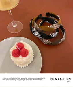 Detail of twisted houndstooth and solid fabric headbands in a lifestyle setting