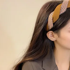 Twisted houndstooth headband for women featuring ginger yellow and russet fabric design